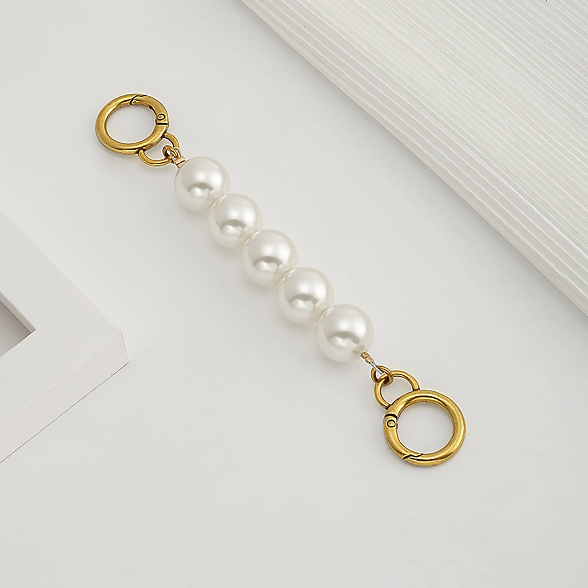 Underarm bag strap extension accessory, pearl extension chain, metal chain strap modification for bags.